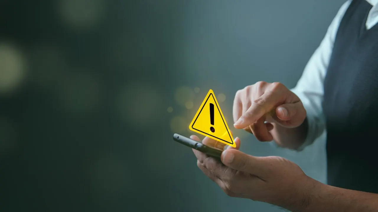 System hacked warning alert, Man using smartphone with cyber attack network, virus, spyware, scam or Malicious software. Cyber security and cybercrime. Compromised information internet.